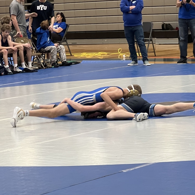 two boys on the mat wrestling