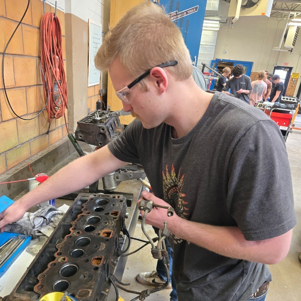 a student working on an engine head