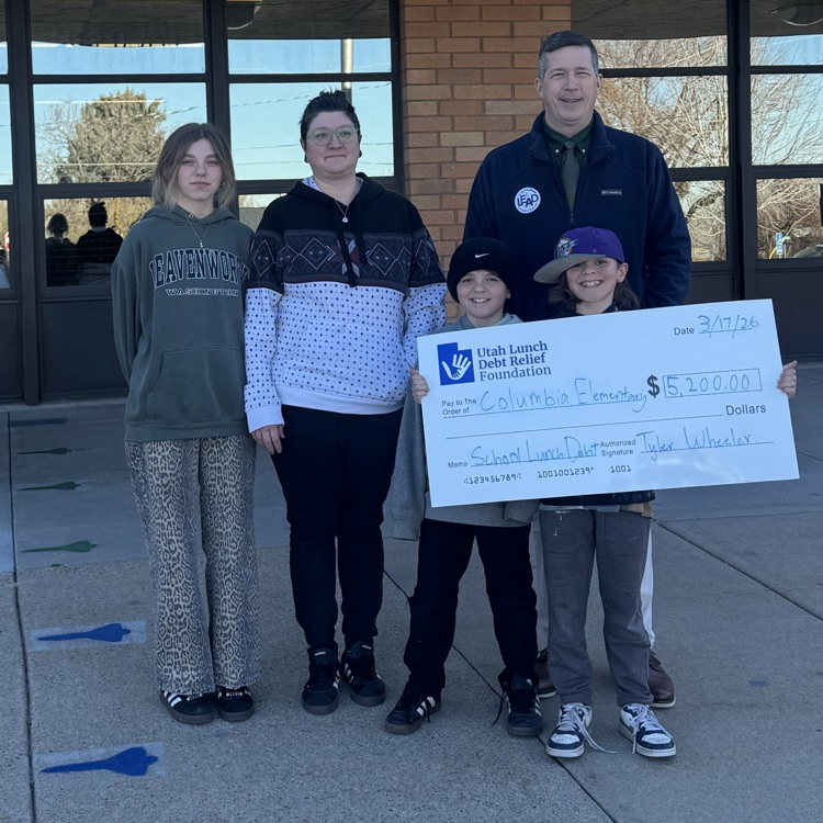 People posing for a picture with a donation check  