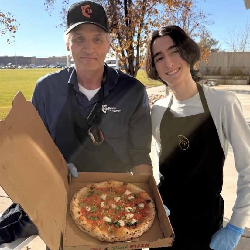 Juan learning to cook fresh margherita pizzas with Brad Goodwin, counselor