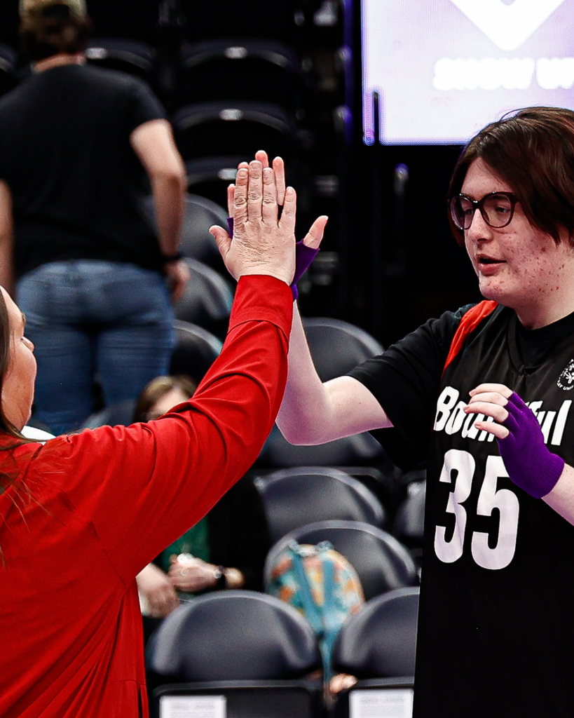 A coach and student high five.