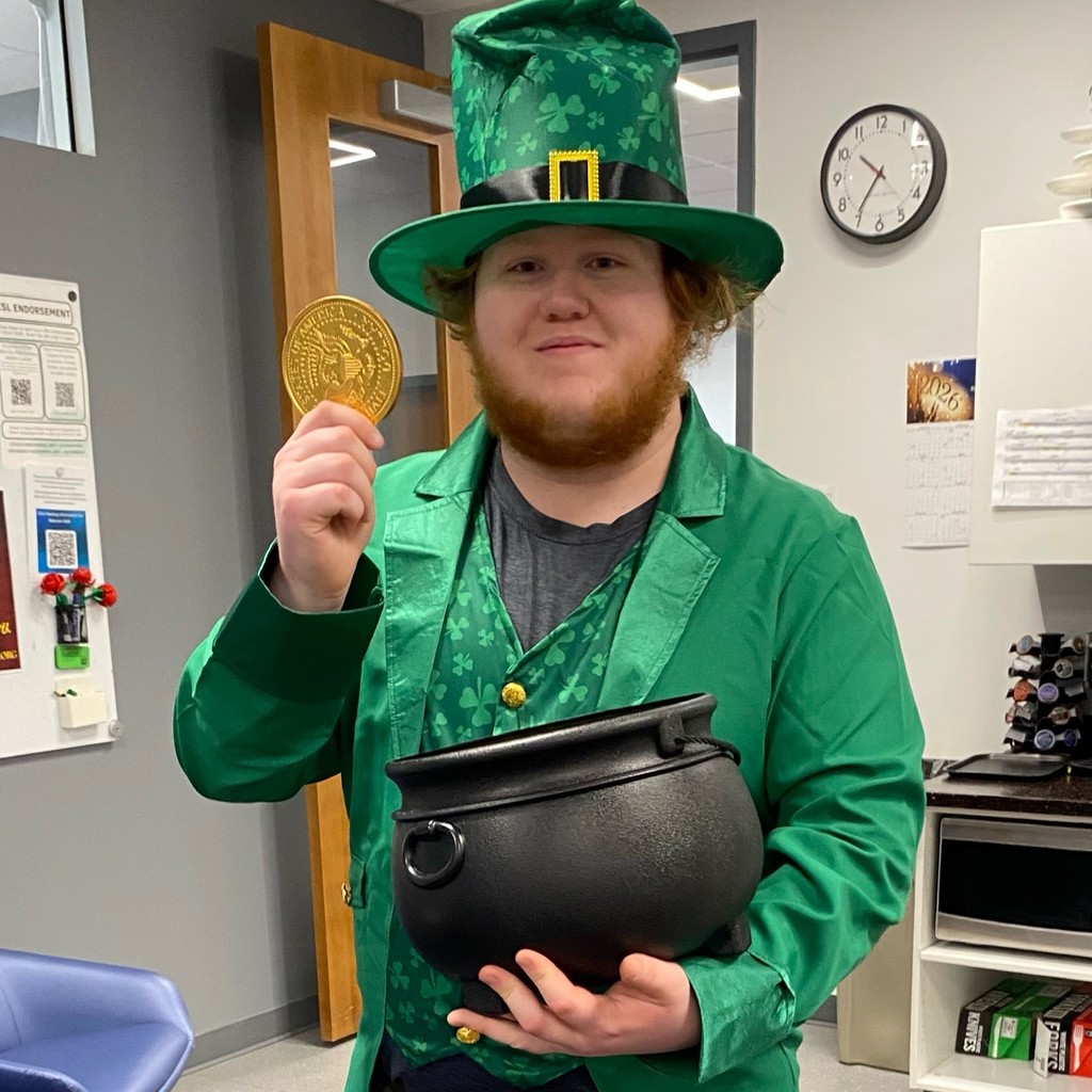 Catalyst student dressed as a leprechaun, giving out chocolate gold coins.
