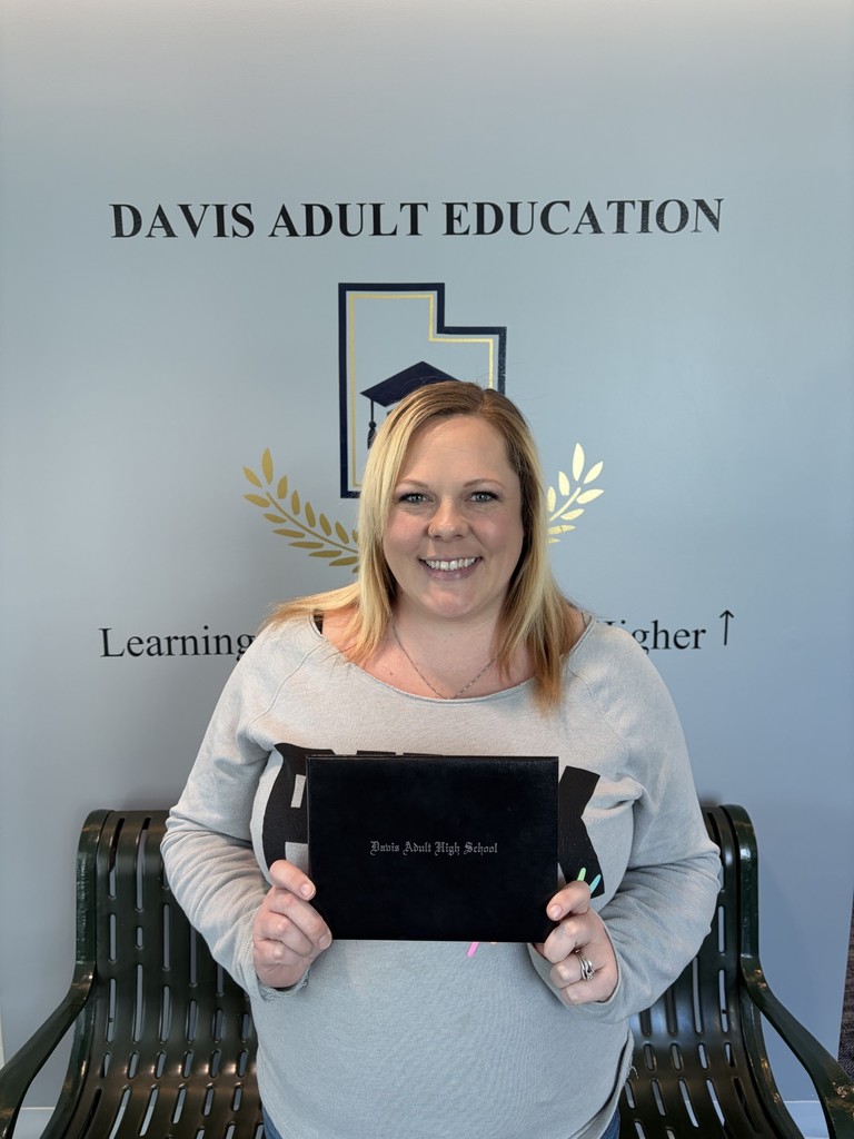 Aryelle Thompson holding her diploma since she finished her Adult High School Diploma