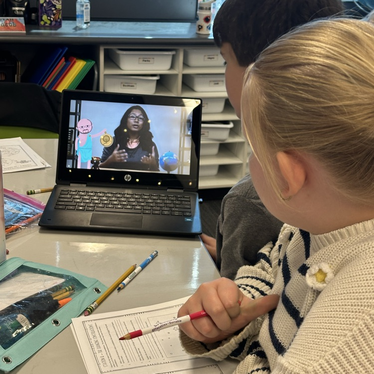2 kids watching a video on a laptop 