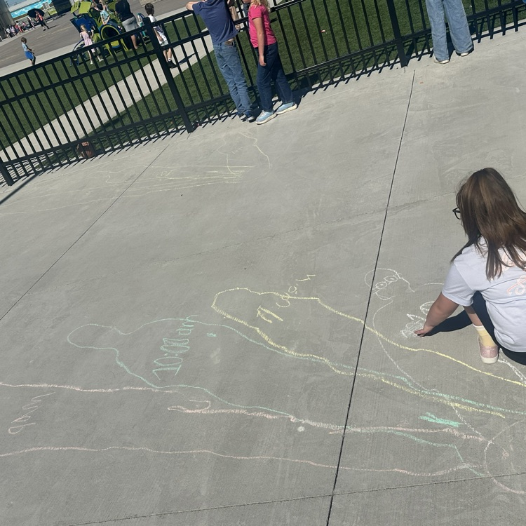 girl on ground looking at traced shadows 