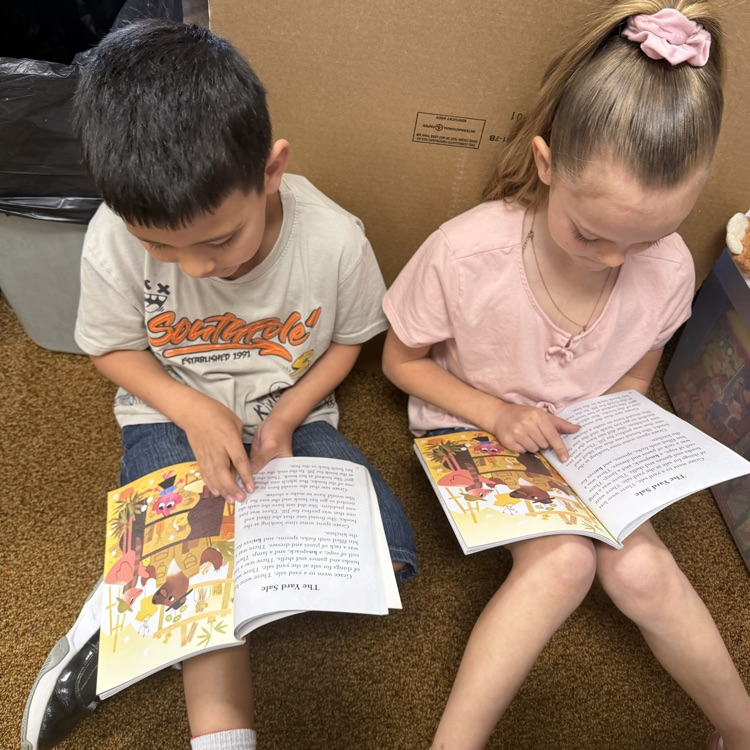 1st graders partner reading to practice fluency