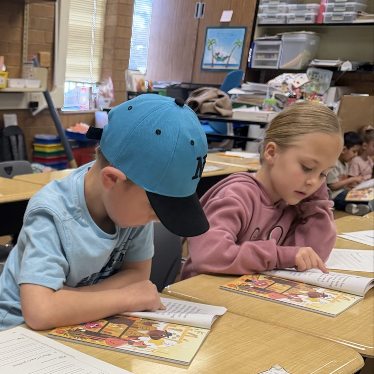 1st graders partner reading to practice fluency
