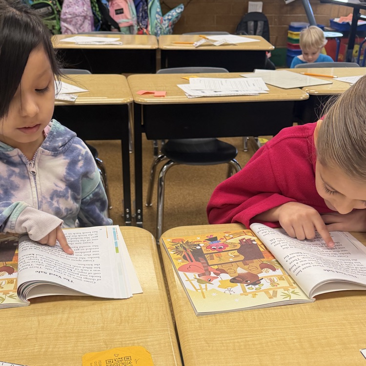 1st graders partner reading to practice fluency