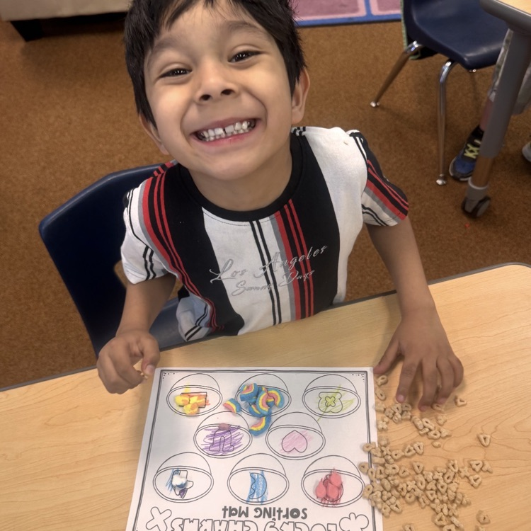 kindergartners doing a math and writing activity on St. Patrick’s day