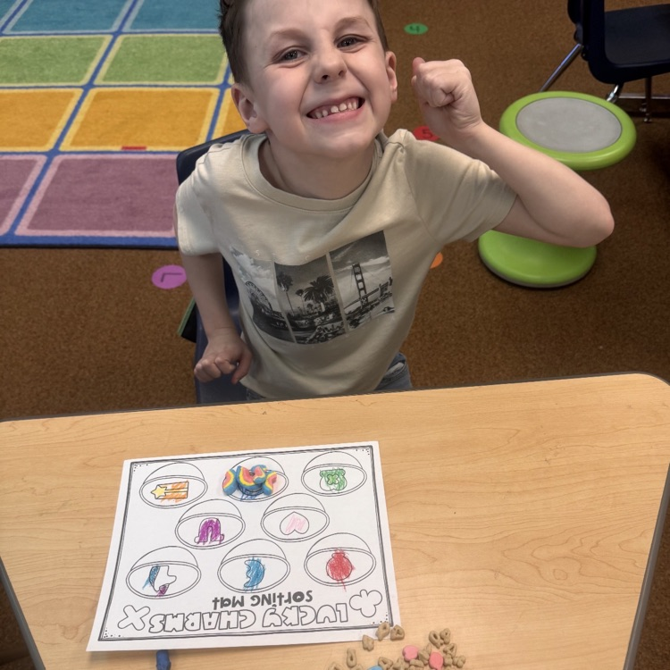 kindergartners doing a math and writing activity on St. Patrick’s day