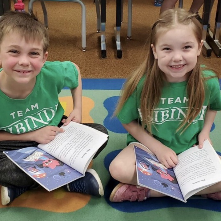 1st graders reading together with a partner to practice their skills