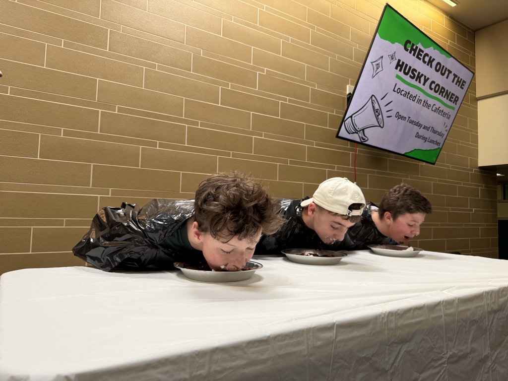 Students participating in a pie eating contest for first lunch. 
