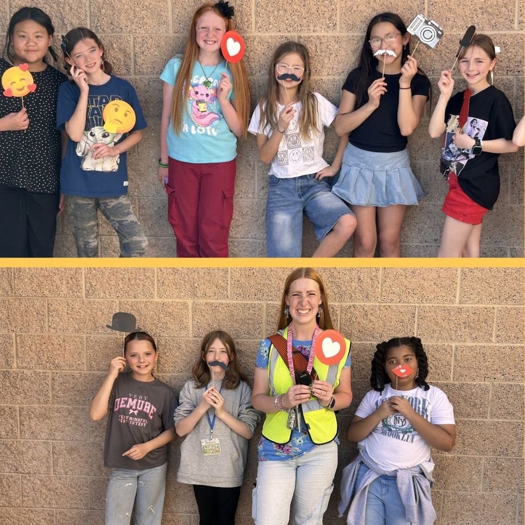 Students pose with fun props out at recess.