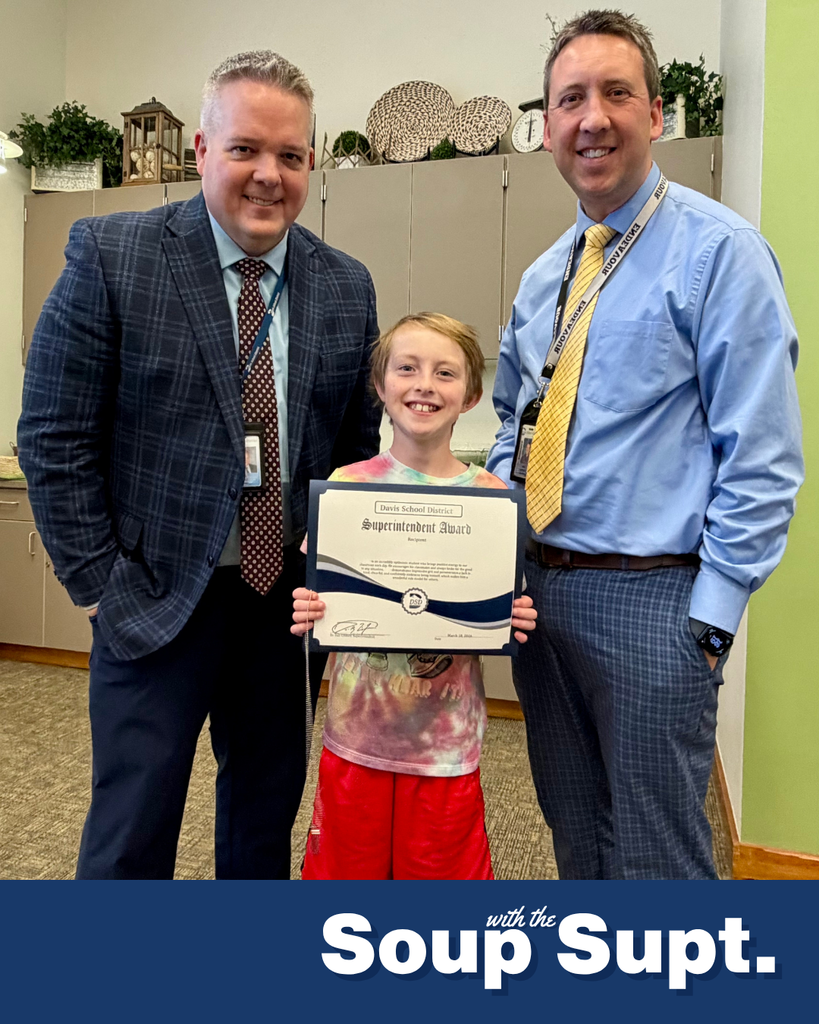 A student smiling with their principal and Dr. Linford, Davis School District Superintendent. 