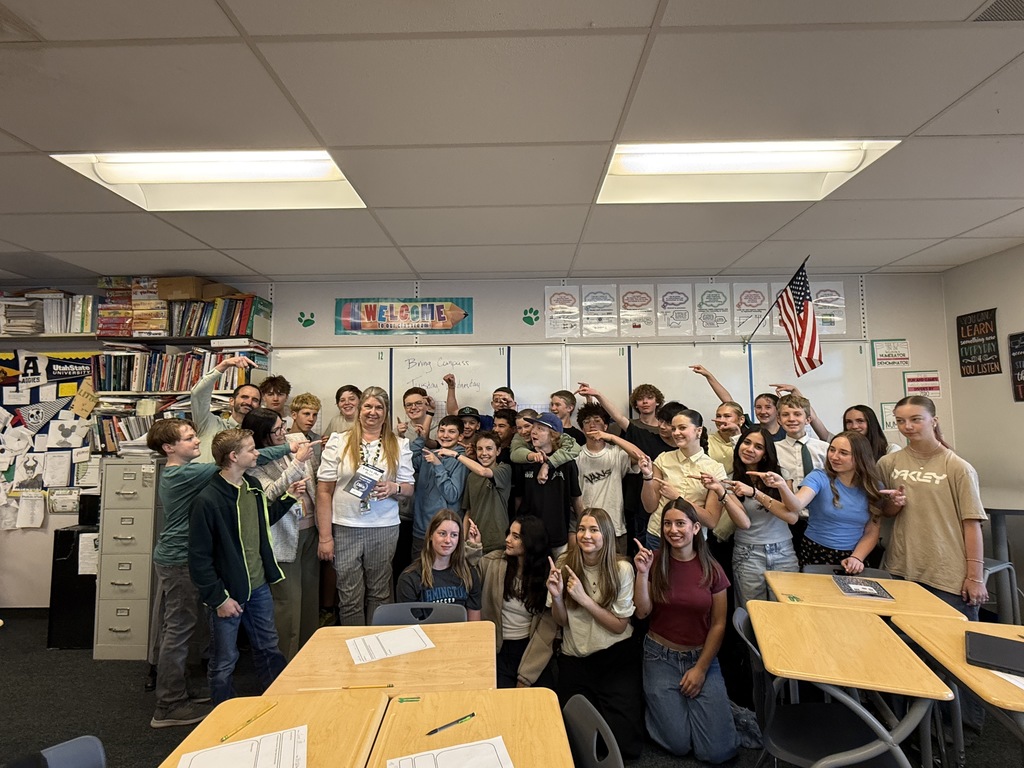 Mrs. Flitton receiving the Best in Davis award with her students pointing at her. 