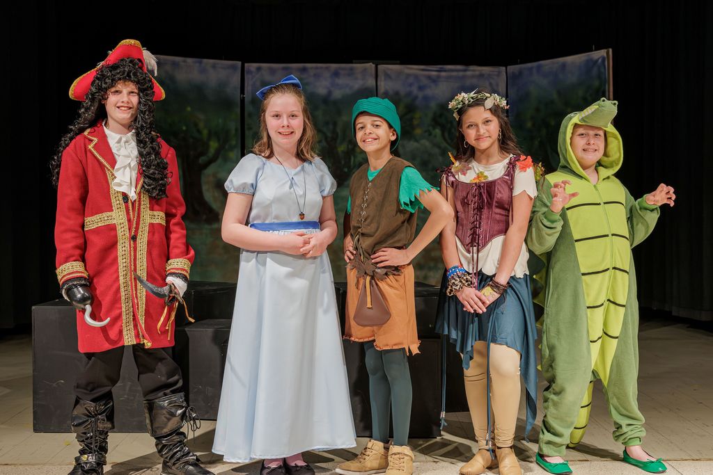 Captian Hook, Wendy, Peter Pan,. Tiger Lily, and the Crocodile posing for a picture