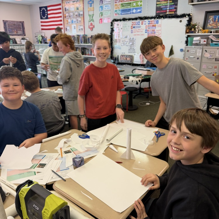 Student students in class preparing for rocket project