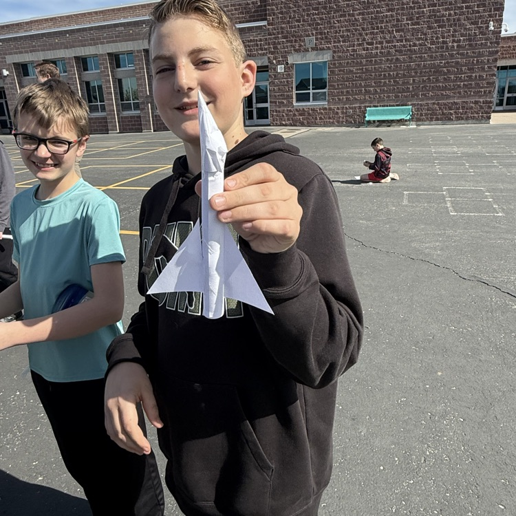student with paper rocket