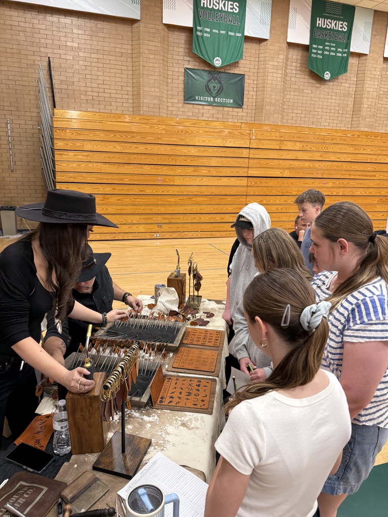Students learning about leather stamping. 