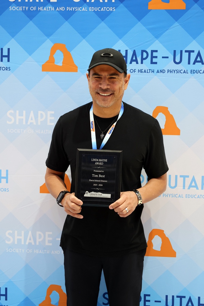 Dr. Tim Best smiling while holding his award that says: "Linda Mayne Award Presented to Tim Best Davis School District 2025 - 2026 SHAPE-Utah."