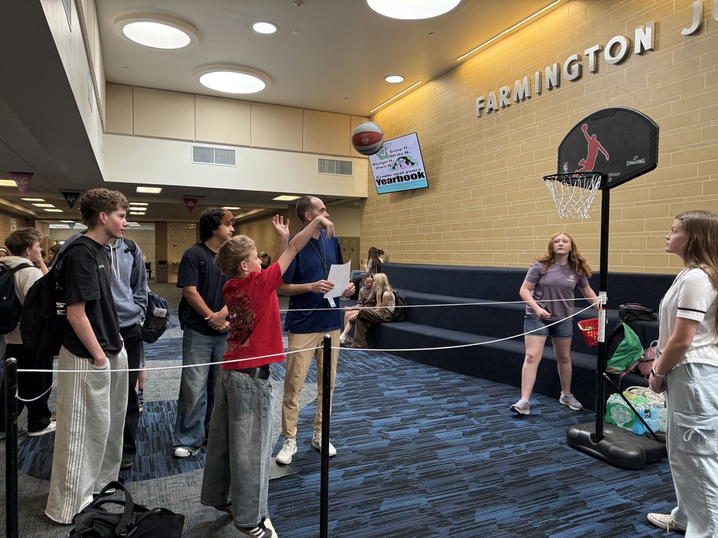 Another student correctly answered a  question about ways to pay for college and shot a basket. 