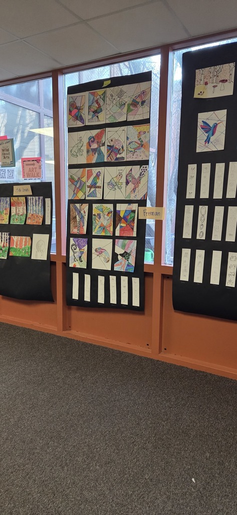 A photo ol children show off their projects from wild about arts night.