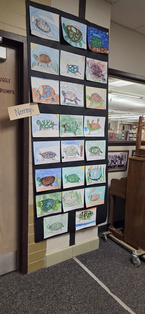 A photo ol children show off their projects from wild about arts night.