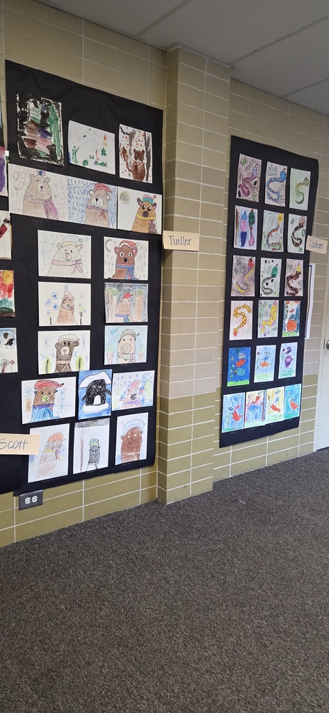 A photo ol children show off their projects from wild about arts night.