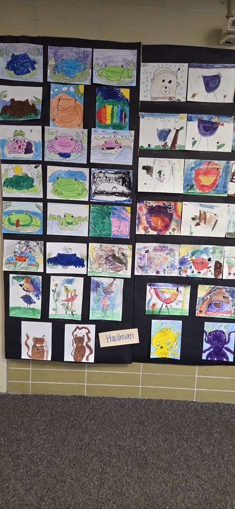 A photo ol children show off their projects from wild about arts night.