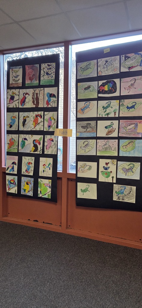 A photo ol children show off their projects from wild about arts night.