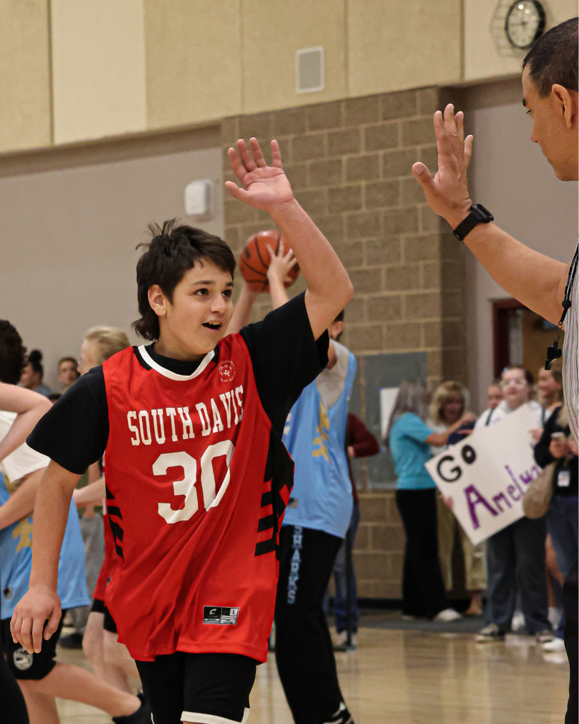 A South Davis Junior High student wearing the number 30 gets ready to high five the ref.