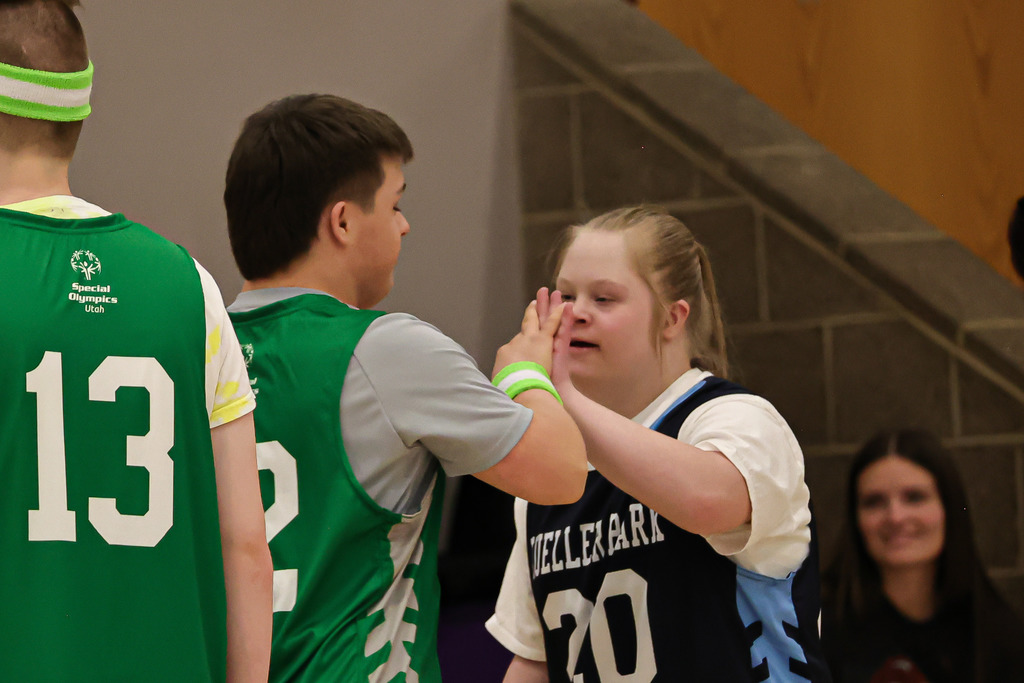 Unified Sports Athletes giving each other high fives during the game.
