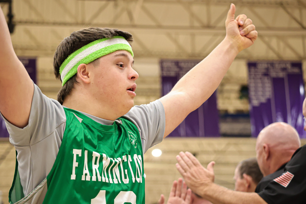 Student with Special Needs making a thumbs up sign during Unified Sports basketball.
