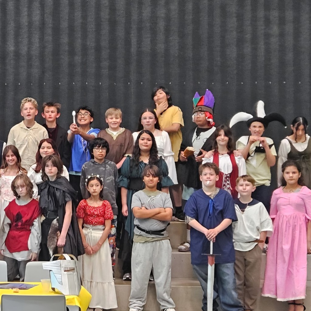 Students smile and pose in medieval-themed clothing during Bountiful Elementary’s 6th grade Medieval Feast.