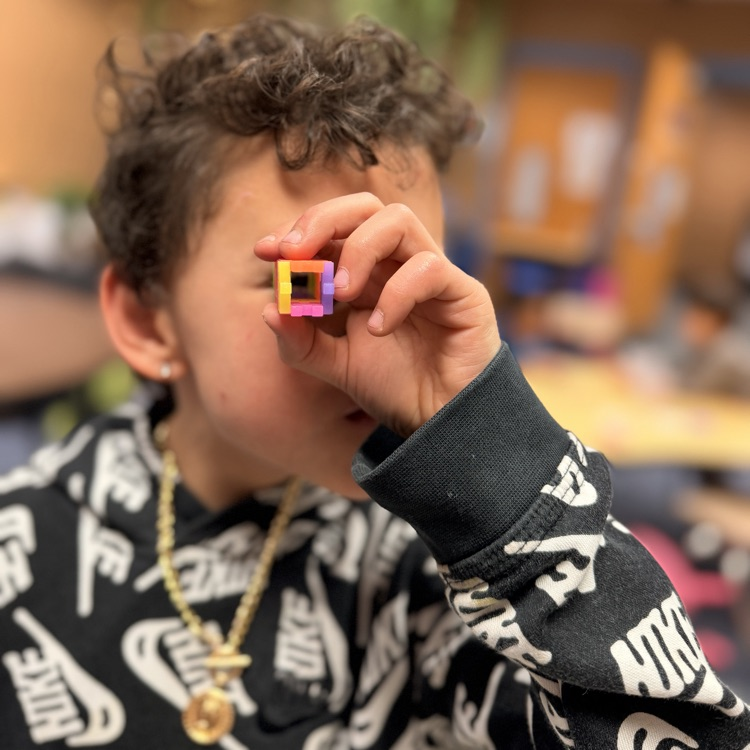 Student looking through toy! 