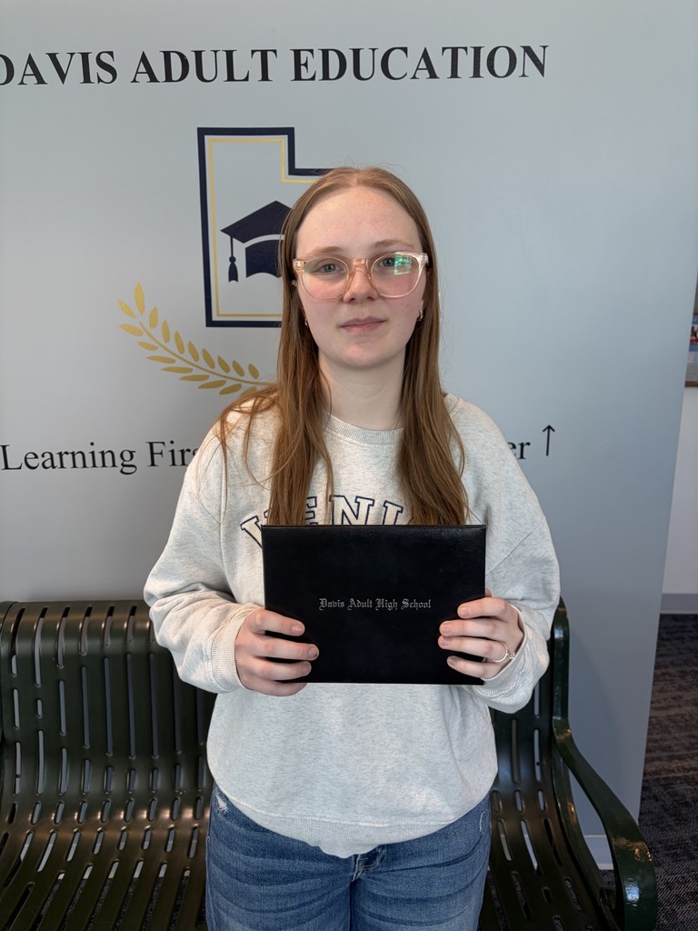 Jacelyn Van Dyke holding her diploma