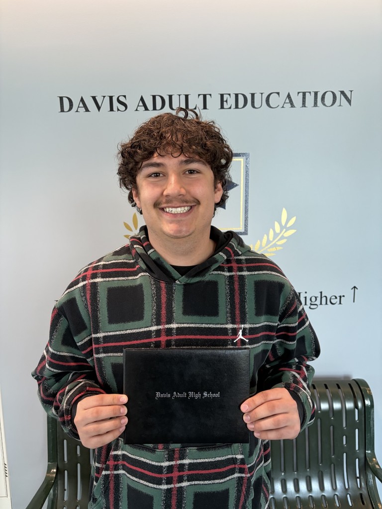 Elijah Mort holding a diploma