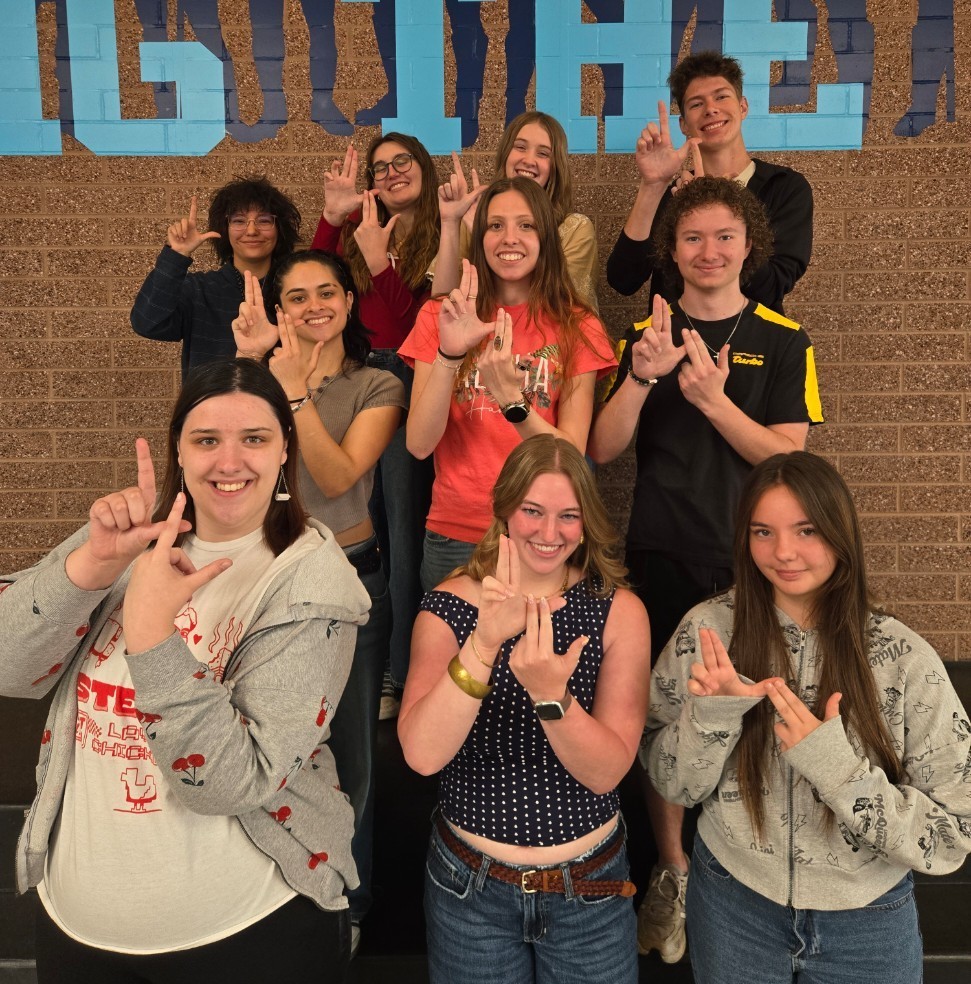 10 students of the month holding their hands in the double L for Layton Lancers