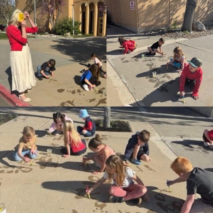 kindergartners practicing writing tricky sight words outside using water and brushes on the sidewalk