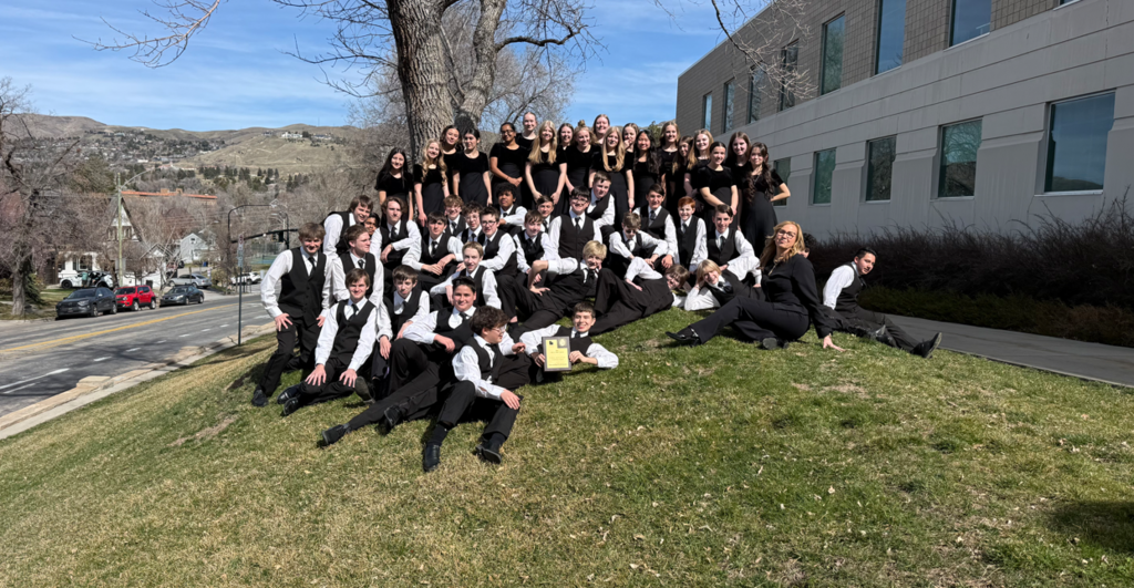 Band Students on the grass outside a building