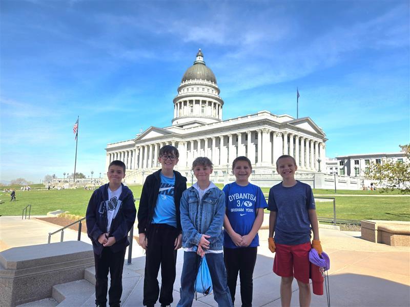 boys standing in front of a large capitol building