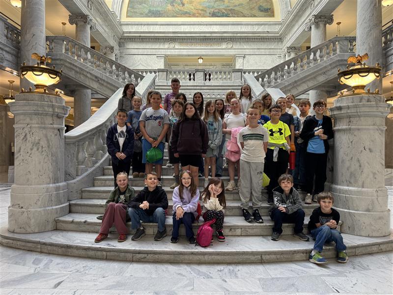 group of students on steps made of marble