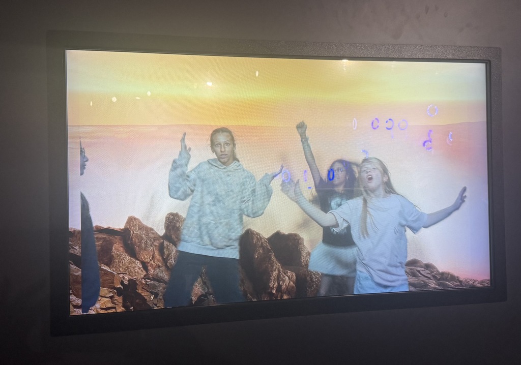 girls broadcasted on to a tv screen with mars landscape behind