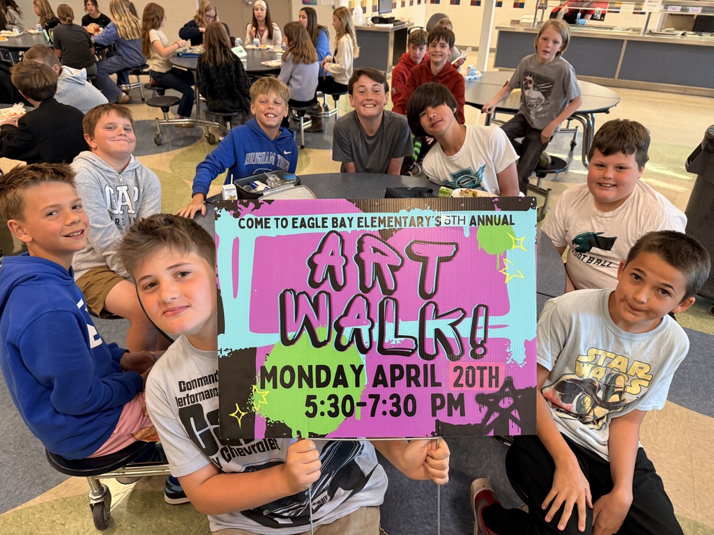 Students hold up a poster advertising Art Walk!
