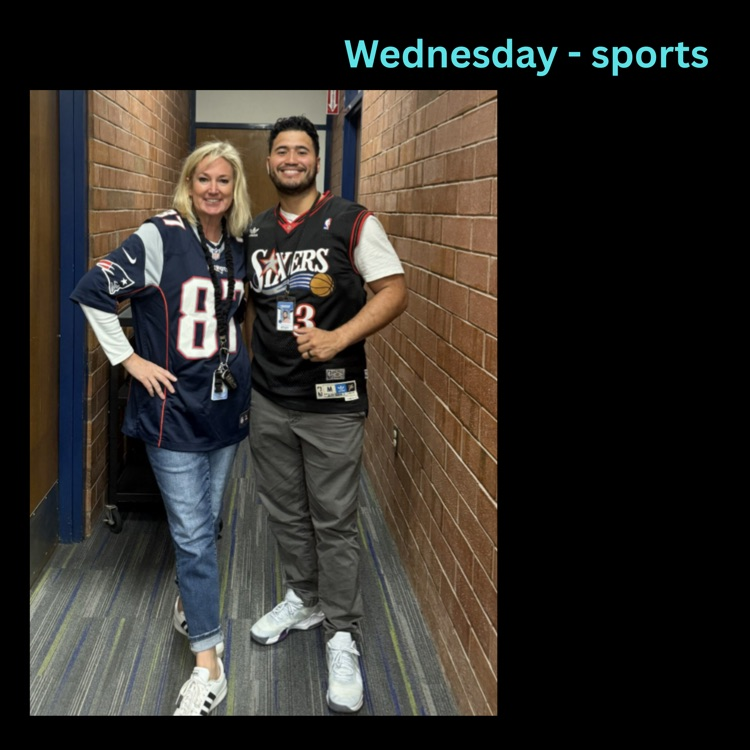 Two teachers standing in a hallway wearing sports jerseys for sports-themed day