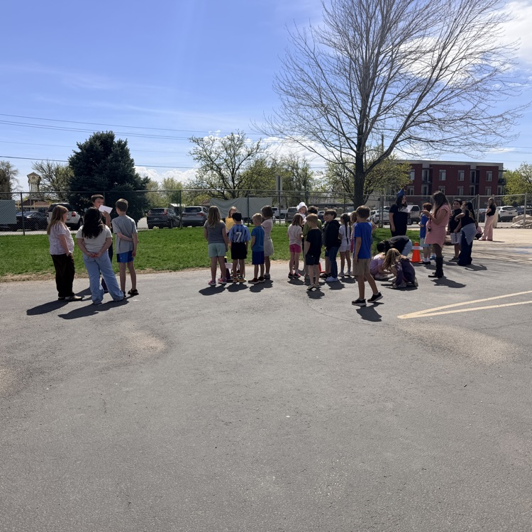 students showcasing their wax museum characters with others in the school