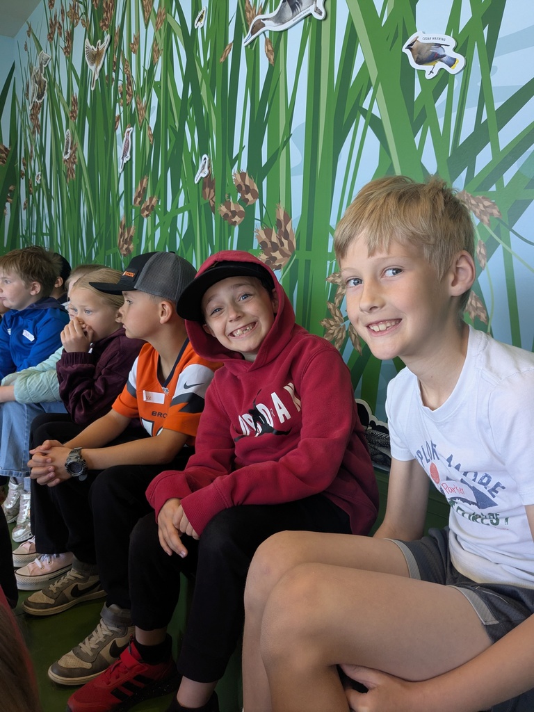 Students posing for a picture at wildlife center.