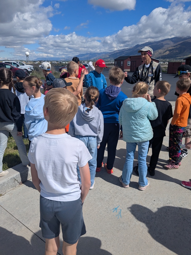 Students learning about birds  from a field trip guide.