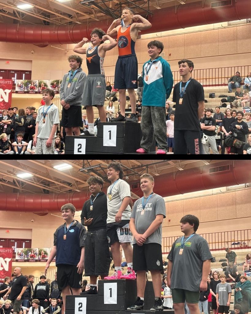 A group of boy wrestlers standing on the podium after a competition