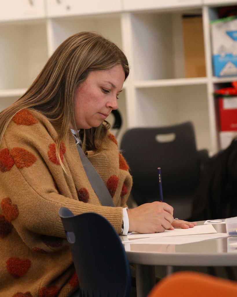 A parent in a classroom drawing.
